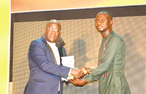  Mr Shaddrach Adjettey Sowah (left), the Managing Director of Golden Star Wassa Ltd, presenting a plaque to Mr Timothy Ngnenbe, winner of the Best Mining Reporter category at the GMIA