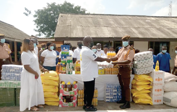 Chief Kofi Ohene (left), a businessman,  presenting the items to Supt Emmanuel Darfour, the acting 2IC of the James Camp Prison
