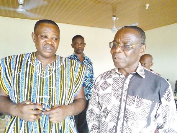 Barima Kyei Gyanpomadu Abrokwa II (left), Chief of Abesim, explaining the danger posed by the pits of Xtra Gold Mining Company to Mr Seth Asante, DCE for Atiwa West