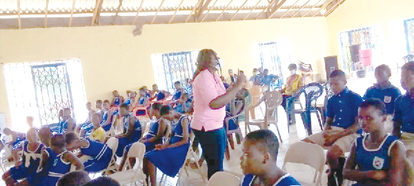 Ms Rebecca Ametepey, a nurse at the Kpong Ensign College of Public Health,  addressing the pupils