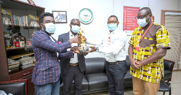 Mr Kobby Asmah (2nd from right), Editor, Daily Graphic, receiving the Newspaper of the Year Award presented to him in his office by Dr Kwabena Abrokwa (2nd from left), Board Chairman, and Mr Prince Markey (left), CEO, both of Big Events, the organisers of the RTP Awards. With them is Mr Samuel Doe Ablordeppey, News Editor of the Daily Graphic