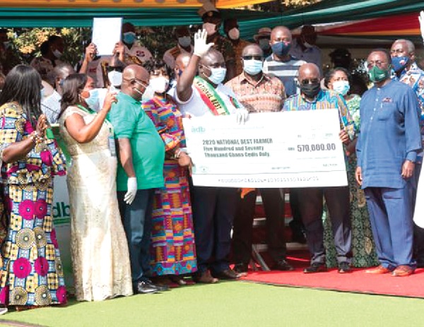 FLASHBACK: Mr Solomon Kwadwo Kusi (with hand raised), the 2020 National Best Farmer, recieving a dummy cheque from President Nana Addo Dankwa Akufo-Addo (2nd from right) while Dr Owusu Afriyie Akoto (right) and other guests look on