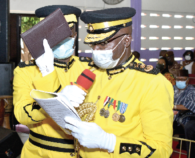 Mr. Isaac Kofi Egyir, the newly inducted Director- General of the Ghana Prisons Service, taking an oath at the induction ceremony. Picture: GABRIEL AHIABOR