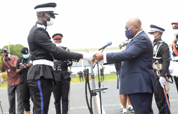 President Nana Addo Dankwa Akufo-Addo presenting the overall best Cadet Officer award to Cadet Officer Ernest Kwofi (left), at the 50th Cadet Officers Graduation Parade in Accra