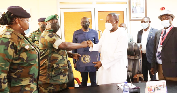 Brigadier General Twum Ampofo-Gyekye (2nd from left), Director-General in Charge of Training at the Ghana Armed Forces General Headquarters, exchanging documents with Rev. Fr Prof. Anthony Afful-Broni (3rd from right), Vice-Chancellor of the University of Education