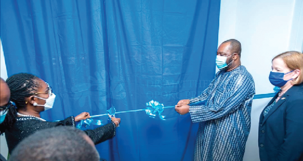 Mrs Ursula Owusu-Ekuful (left), Communications and Digitalisation Minister, assisted by Dr Mathew Opoku Prempeh (middle), Energy Minister, and other guests to cut the tape for the launch of the new entity