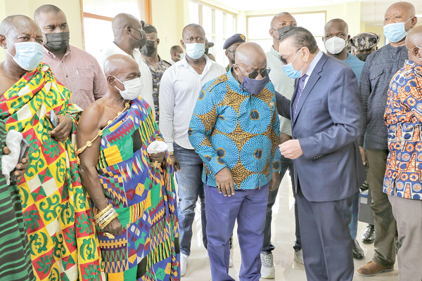 President Akufo-Addo (2nd from right) in a chat with Dr Said Deraz (right), Chairman of Euroget Group,  during the visit to the Sawua Hospital. With them is Nana Amankwaa Sarkordie II (2nd from left), the Sawuahene