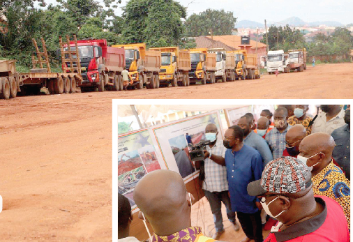 Heavy duty vehicles on site on the Kwadaso-Trabuom road. INSET: President Nana Addo Dankwa Akufo-Addo (arrowed), inspecting displayed pictures on the ongoing 15.2 KM Kwadaso-Trabuom road