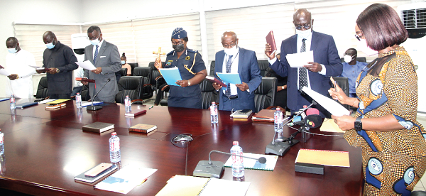  Ms Abena Osei Asare (right), a Deputy Minister of Finance, administaring the oath of office to the Financial Intelligence  (FIC) Board. Picture: ESTHER ADJEI 