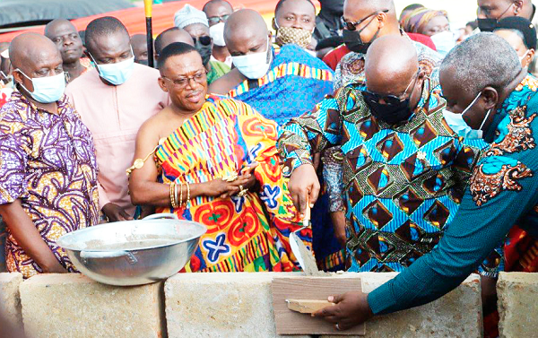 President Akufo-Addo laying the foundation block for the start of the project at Bidiem, while Oguashia Oduropanin Birikorang (in Kente), the Edubiasemanhene; Mr Simon Osei Mensah (left), the Ashanti Regional Minister, and others look on.   Picture: EMMANUEL BAAH