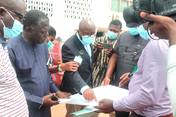 Dr Frank Baning (2nd from left), Director, Pantang Hospital, and Mr Benito Owusu-Bio (1st from left), Deputy Minister of Lands and Natural Resources, assessing the land documents of the hospital. Picture: Maxwell Ocloo