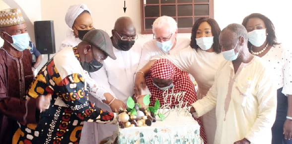 Vice-President Dr. Mahamadu Bawumia (arrowed) being assisted by his wife, Samira, Ms. Shirley Ayorkor Botchwey  and some staff and members  of the Weija Leprosarium, to cut a cake to mark his birthday in Accra. Picture: Patrick Dickson 