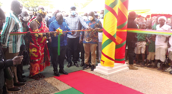 President Akufo-Addo being assisted by Obrempong Sintim Poku III, the Mansohene, to cut the tape to inaugurate the new office complex. Picture: SAMUEL KYEI-BOATENG