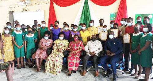 Ms. Justina Marigold Assan (seated 2nd from left), Central Regional Minister, with officials and students of some institutions that received the Head of State Award sub-licences in the Central Region