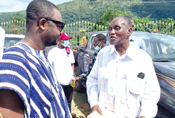 Mr Richard Kings Atikpo (left) interacting with Dr Obed Asamoah, a native of the area