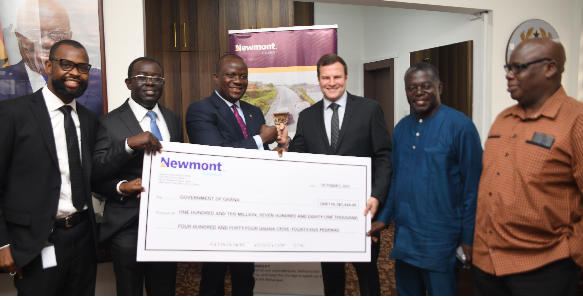 Mr. Francois Hardy (3rd from right), the Regional Senior Vice-President of Newmont Africa, presenting the dummy cheque for GH¢110,781,444 to Mr. Samuel Abu Jinapor (3rd from left), Minister of Lands and Natural Resources, in Accra. Looking on are some officials of the company.