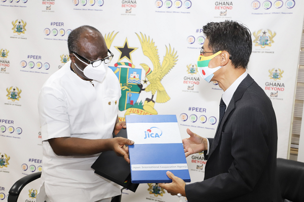 Mr Ken Ofori-Atta (left), Minister of Finance, and Mr Araki Yasumichi, Chief Representative of JICA, Ghana Office, exchanging the signed documents at the ceremony in Accra.  Picture: GABRIEL AHIABOR