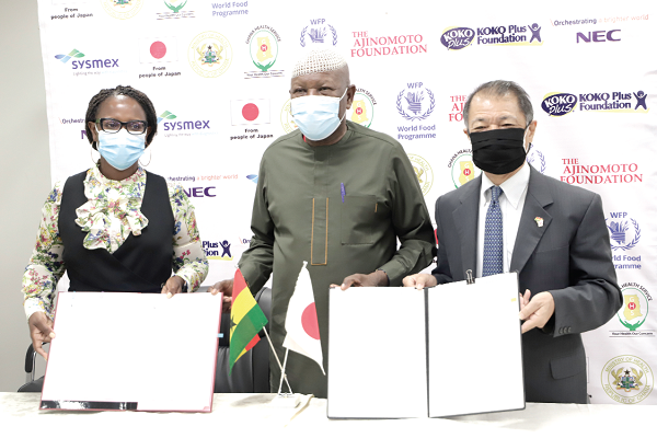 Mr Tsutomu Himeno (right), the Japanese Ambassador to Ghana, and Ms Anna Mukiibi-Bunnya (left), acting Country Director, World Food Programme, displaying the signed documents . With them is Mr Mahama Asei Seini (middle), a Deputy Minister of Health. Picture: EDNA SALVO-KOTEY