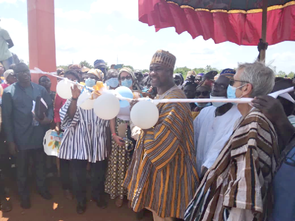 Mr Hardi Tuferu (2nd right), Deputy Minister of Food and Agricture in charge of Livestock, cutting the tape to inaugurate the market• Inset: Entrance to the Gushegu Livestock Market