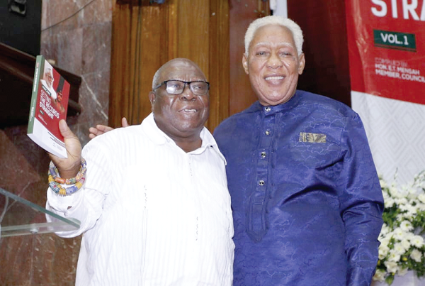  Mr Daniel Abodakpi (left), a member of the Council of Elders of the National Democratic Congress, launching the book with Mr Mensah, the author. Picture: NII MARTEY M. BOTCHWAY 