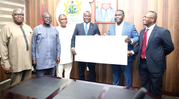 Mr Eric Asubonteng (right), Managing Director of Anglo-Gold Ashanti, presenting the dummy cheque to Mr Samuel Abu Jinapor, Minister of Lands and Natural Resources. With them are Mr George Mireku Duker (2nd from left) and Mr Benito Owusu-Bio, deputy ministers of Lands and Natural Resources.  Picture: Emmanuel Quaye 