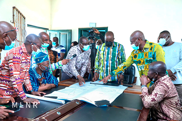  Mr James Dadson (arrowed), acting Executive Director of the Lands Commission, explaining a point to Mr Samuel Abu Jinapor (standing 3rd from right), Minister of Lands and Natural Resources