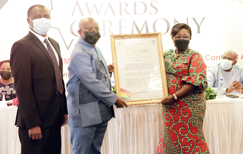 Mrs Akosua Frema Osei-Opare (right), Chief of Staff, presenting the Best Performing Regional Coordinating Council award to Mr Archibald Yao Letsa (2nd  from left), Volta Regional Minister, during the event. Picture: EDNA SALVO-KOTEY