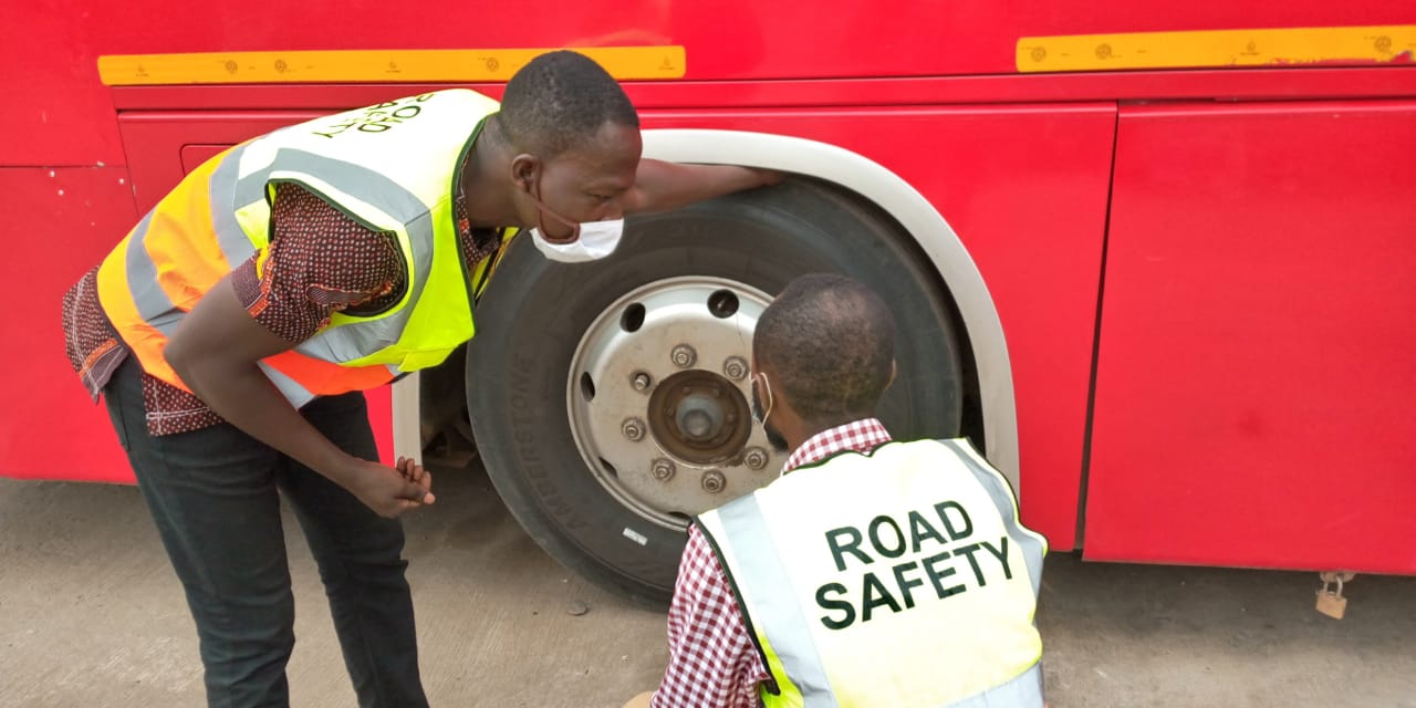 Road safety inspectors examining the engine of an STC coach