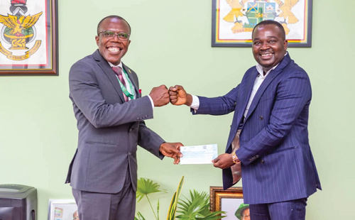 The Pro-VC (left) receiving the cheque from Mr Appiah