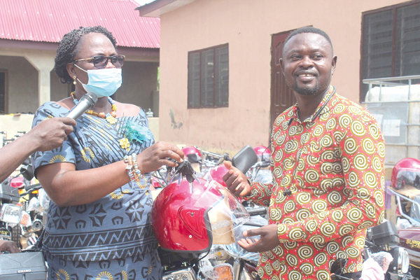 Mrs Justina Owusu-Banahene (left), Bono Regional Minister, presenting the keys to Mr Joseph Baffour Awuah, the Dean of the Presiding Members