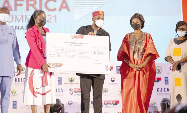 Mr Pius Hadzide (3rd from left), the Chief Executive Officer of the National Youth Authority, showcasing Ghana's innovation award, as Ms Ahunna Eziakonwa (right) looks on