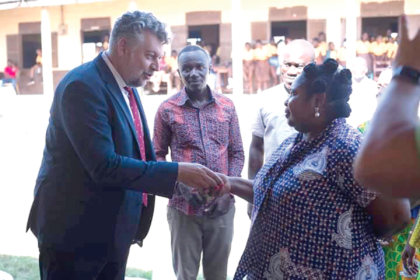 Robert Hruby handing over the keys to Miss Clara Dorothy Mensah, Headmistress of the school