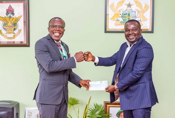 The Pro VC (left) receiving the cheque from Mr Appiah