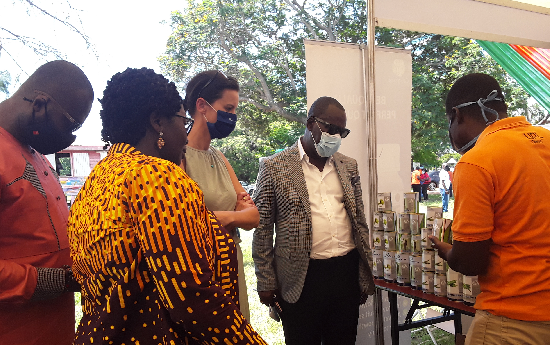 An exhibitor (right) showing a product to Mr. Seth Osei Akoto (2nd from right), Director, Crop Services, MoFA; Katja Lasseur (middle), Deputy Head of Mission, Embassy of the Netherlands; Mrs. Sheila Assibey-Yeboah (2nd from left), Programme Manager, HortiFresh West Africa, and Mr. Anthony Morrison (left), CEO, CAG