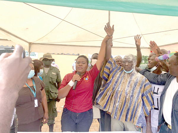 The Municipal Electoral Officer, Nana Esi Dadzie, raising the hands of Mr Bashiru to confirm his approval