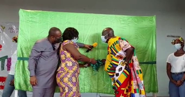 Mr Pius Enam Hadzide (left), CEO, National Youth Authority;  Mrs Justina Marigold Assan (middle), Central Regional Minister, and Osabarimba Kwesi Atta II, Omanhen of Oguaa Traditional Area, cutting the tape to launch the Safeguarding the Teenage Girl campaign