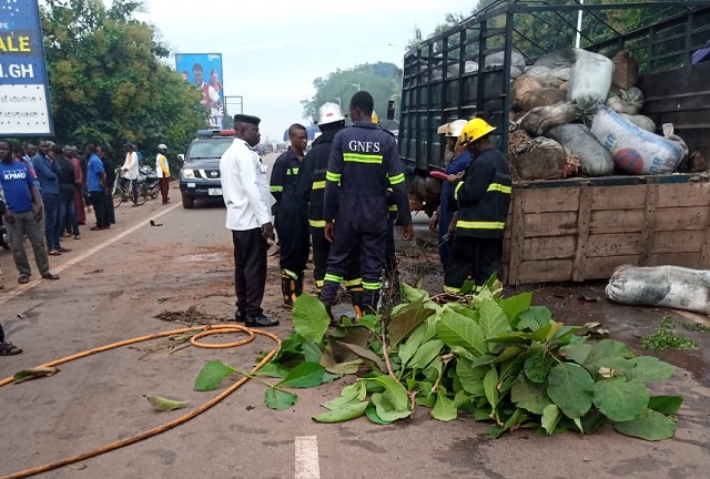 Police at the scene of the accident, while the deceased is covered with leaves 