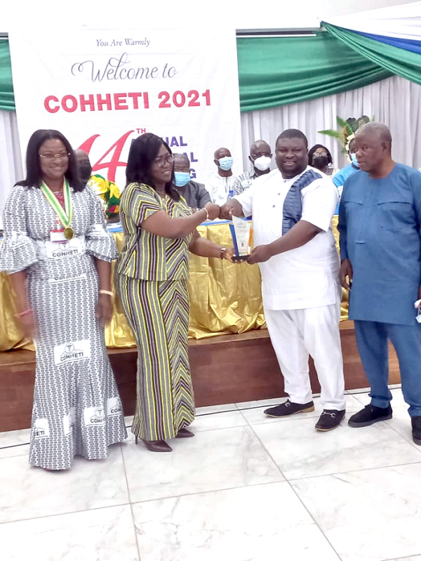 Dr Beyere (2nd from right), receiving his award from the Secretary of COHHETI, Ms Margaret Mary Alacoque (2nd from left)