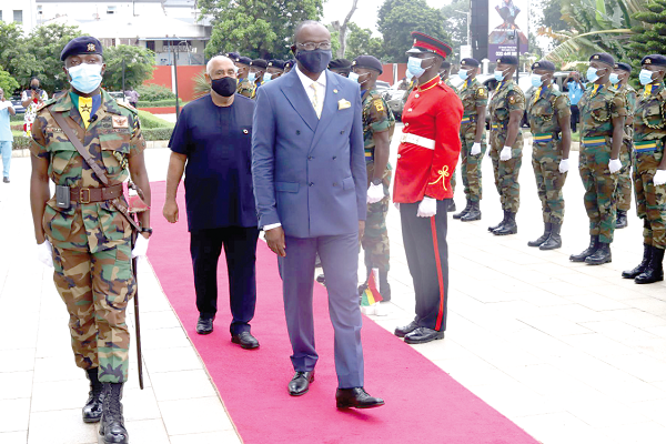 Mr Kwaku Ampratwum-Sarpong (front), Deputy Foreign Affairs and Regional Integration Minister, and Mr Charles Abani, UN Resident Representative in Ghana, jointly inspecting the guard of honour mounted by the Ghana Armed Forces.