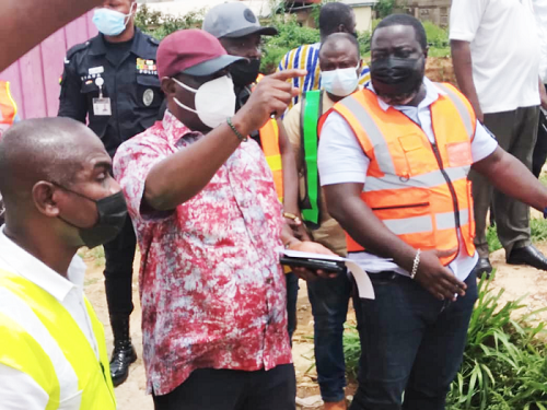 Mr Kwasi Amoako-Attah (arrowed), the Minister of Roads and Highways, with his team inspecting damaged sites, including the storm drain at Kalariga