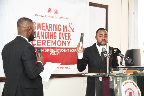Mr Lord Percival Agbavor Jnr (left) administering the oath to Mr Wonder Victor Kutor as the new President of the SRC of the Ghana School of Law. Picture: EBOW HANSON  