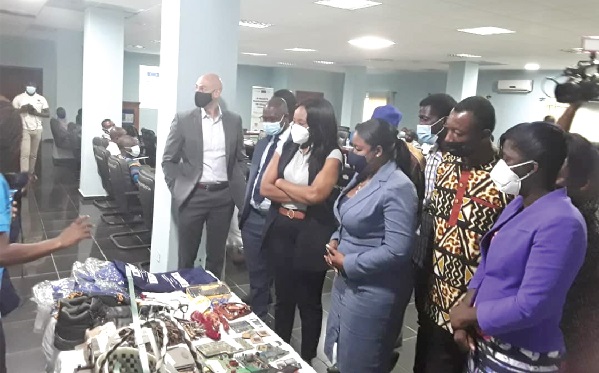 Professor Rosemond Boohene (right), Ms Nana Afua Ababio (3rd right), Ms Viva Bruce (4th right) and other participants appreciating some recycled products of e-waste