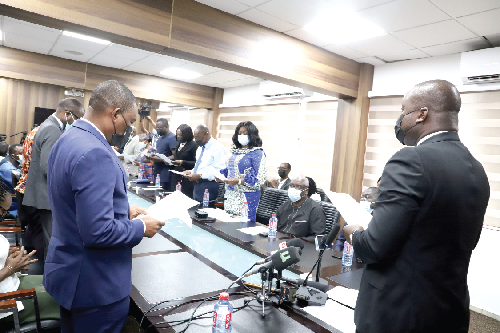 Mr Samuel A. Jinapor (right), Minister of Lands and Natural Resources, swearing the Minerals Commission Board into office in Accra. Picture: GABRIEL AHIABOR