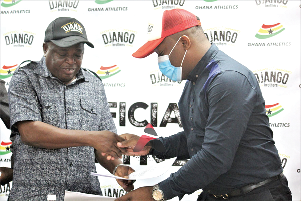 Mr Afelibiek Ababu (left), GAA President, exchanging documents with Mr Chris Opara of Tema Craft Breweries after the signing ceremony yesterday