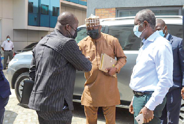 Mr. Samuel Abu Jinapor (left) exchanging pleasantries with Alhaji Umar Farouk Aliu-Mahama, Chairman of GIISDEC board