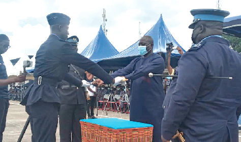 Col. Kwadwo Damoah ( Retd) (2nd right) presenting the overall best trainee award to Junior Cadet Moses Nsobila Adabre