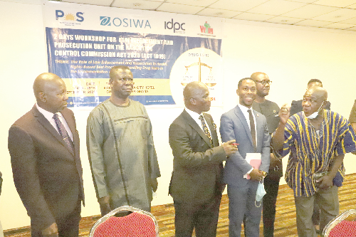 Mr Akrasi Sarpong (right), a former Executive Secretary of the NACOC,  interacting with Justice Bright Mensah (3rd left), Justice of the Court of Appeal, at the workshop organised by the POS Foundation in Accra. Those in the picture include Mr Michael Addo (left), Ag. Deputy Director General of the NACOC; Mr Jonathan Osei Owusu (3rd right), Executive Director of the POS Foundation, and other officials. Picture: GABRIEL AHIABOR