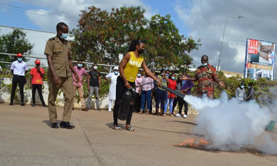 An official of the fire outfit supervising the use of the fire extinguisher. 