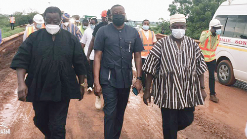 Mr Kwasi Amoako-Atta (left) the Minister of Roads and Highways, and Mr Saeed Muhazu Jbril (middle), the Savannah Regional Minister, inspecting the road from the Kintampo side that linked the Buipe Bridge