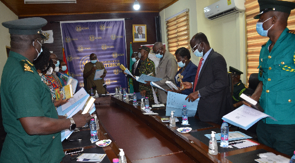 Mr. Ambrose Dery (head of table), the Minister for the Interior, swearing the Ghana Immigration Service Board into office in Accra